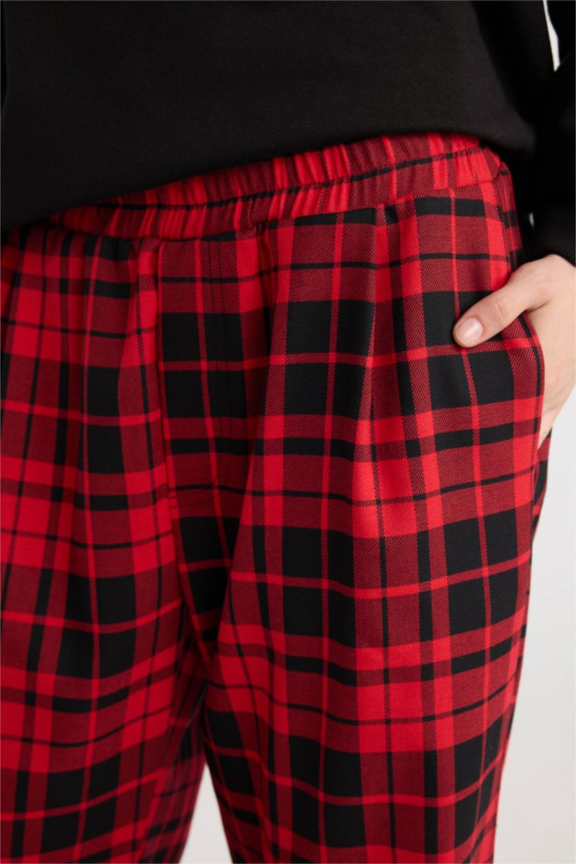 Close up of the buffalo plaid pants elastic waistband and side pocket