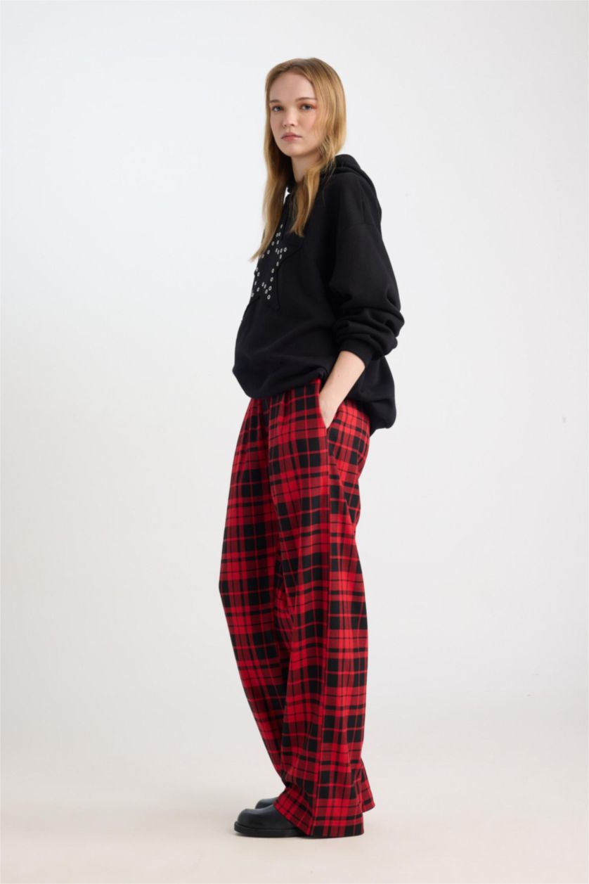 Buffalo plaid pants, side view showing the relaxed fit through the hip