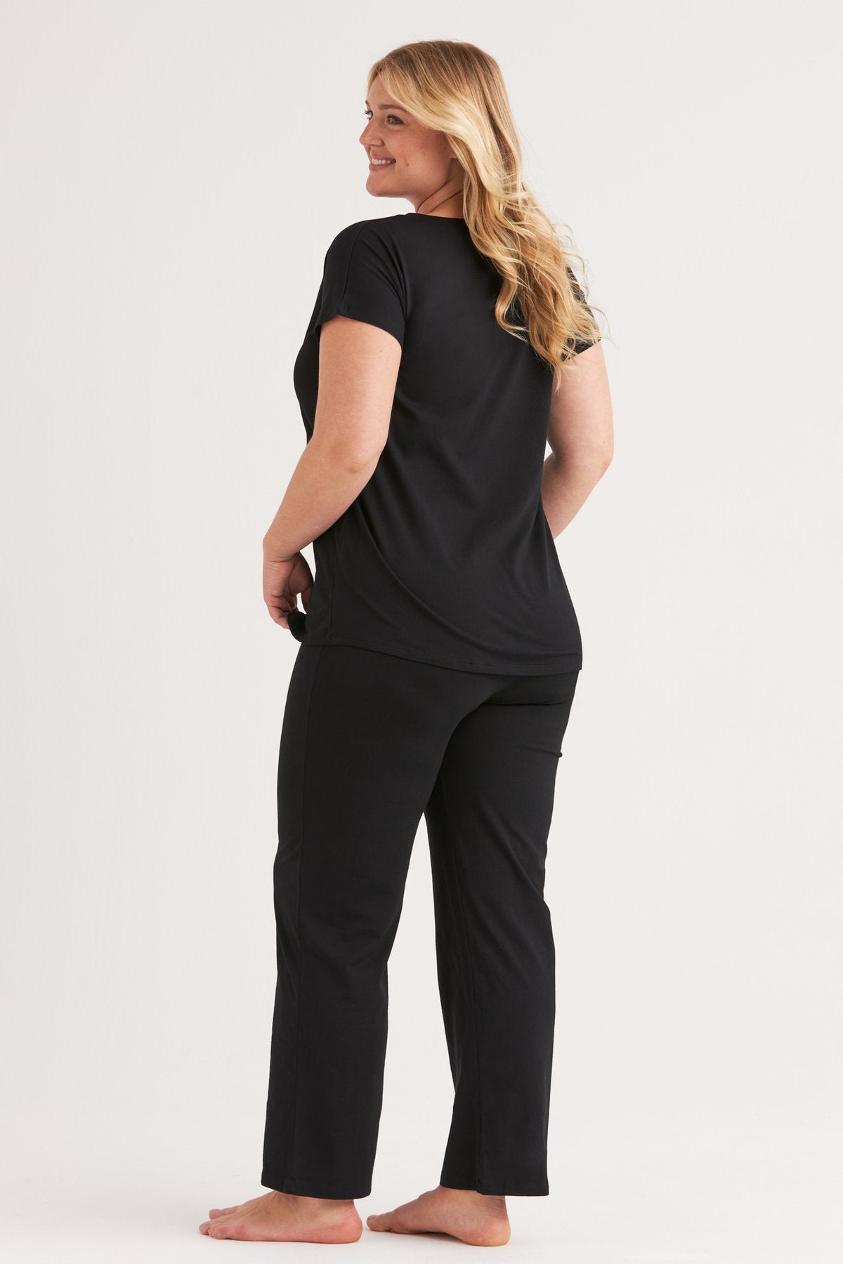 Black cotton pyjama set, side view showing the relaxed fit