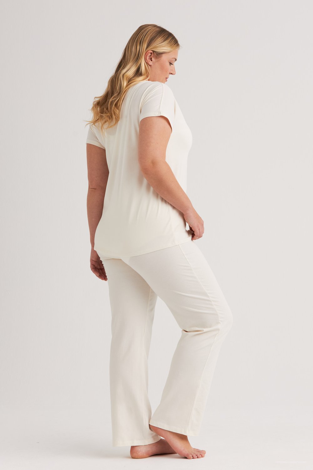Cream cotton pyjama set, back view showing the curved hem and straight leg pants